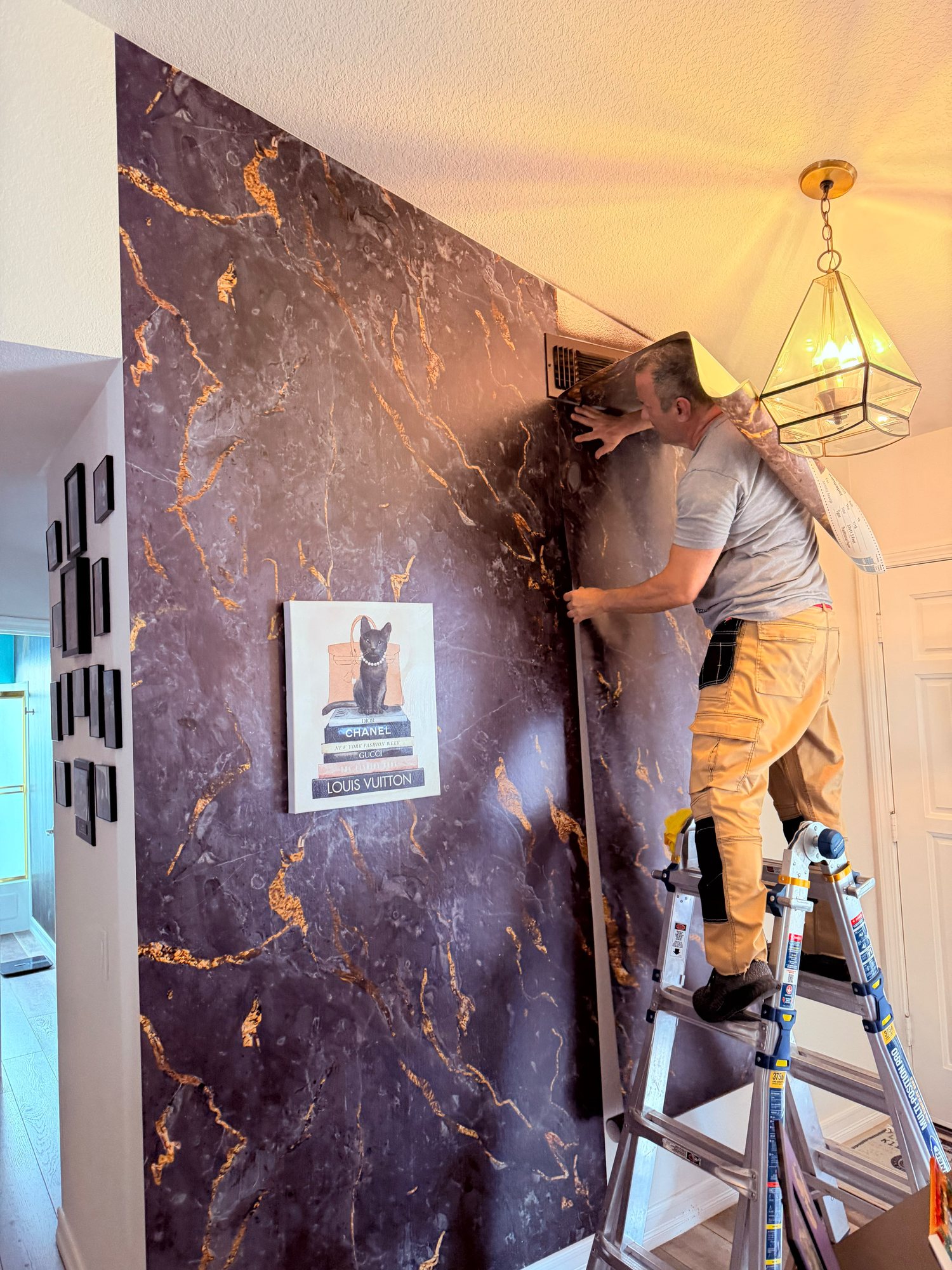 Master installer applying marble wallpaper